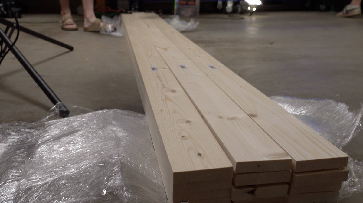 Stacked cut pine boards on the garage floor